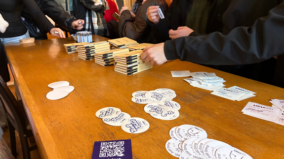 Pierwszoroczni studenci otaczający gadżety UniSTART.